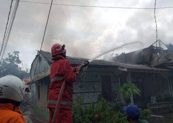 Petugas saat memadamkan rumah yang diduga dibakar, f ; Mael/detak.media